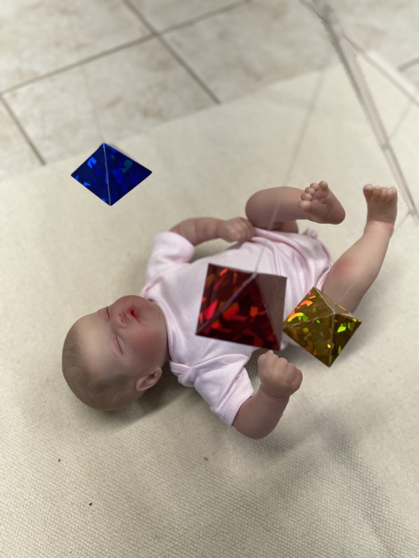 Baby watching a mobile, practicing visual tracking